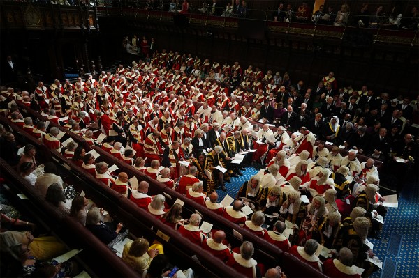 Rows of members of the House of Lords seated in a chamber at the Palace of Westminster in London.