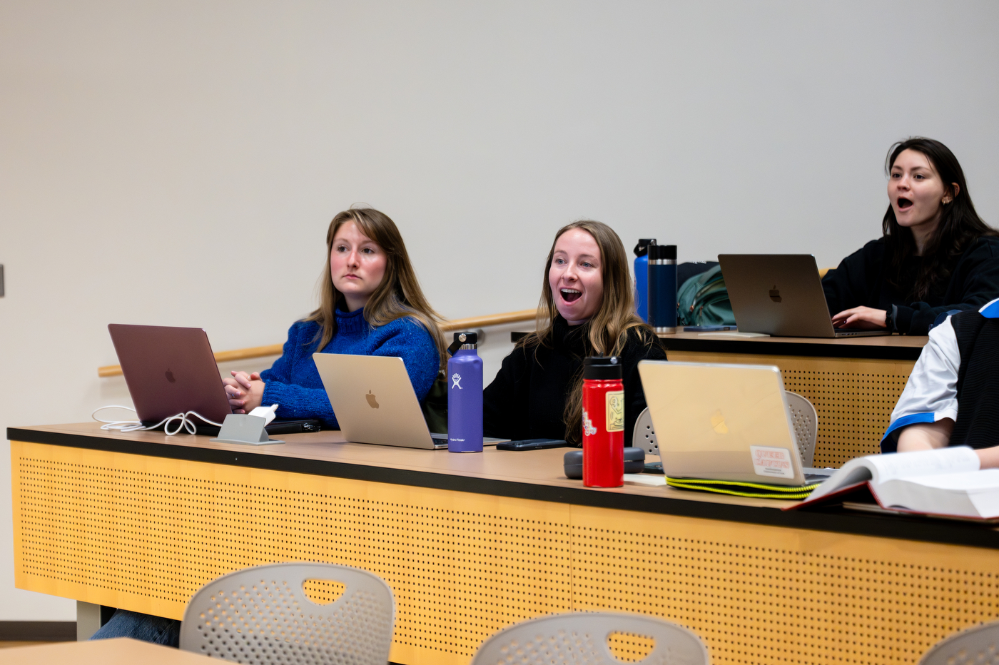 Students in Erin Islo class sit behind their computers with mouths wide open as they see their teacher receive the University Excellence in Teaching Award.