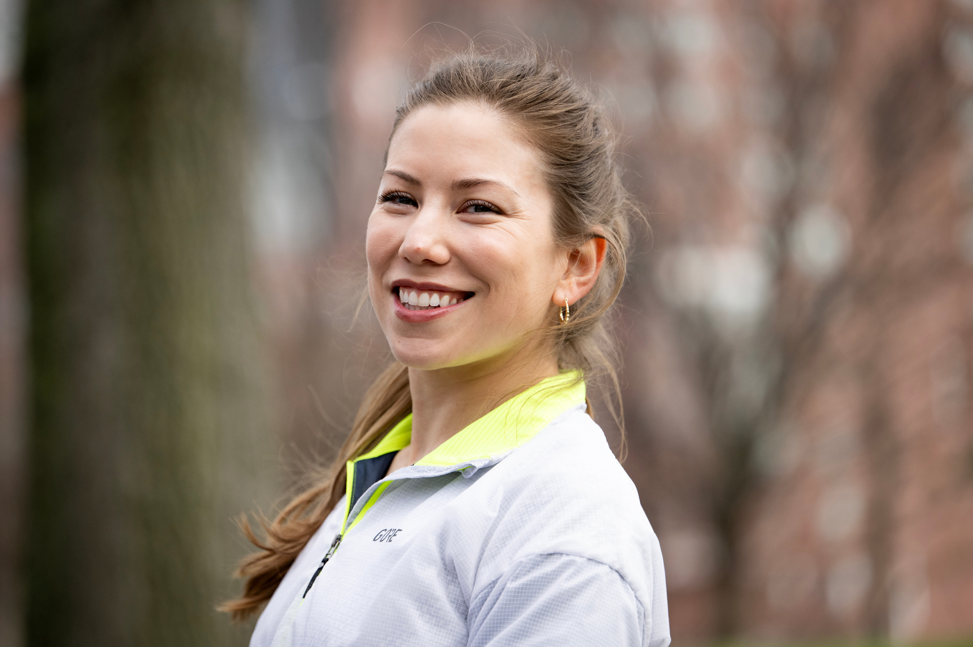 Megan Doe smiles for a portrait in a gray jacket