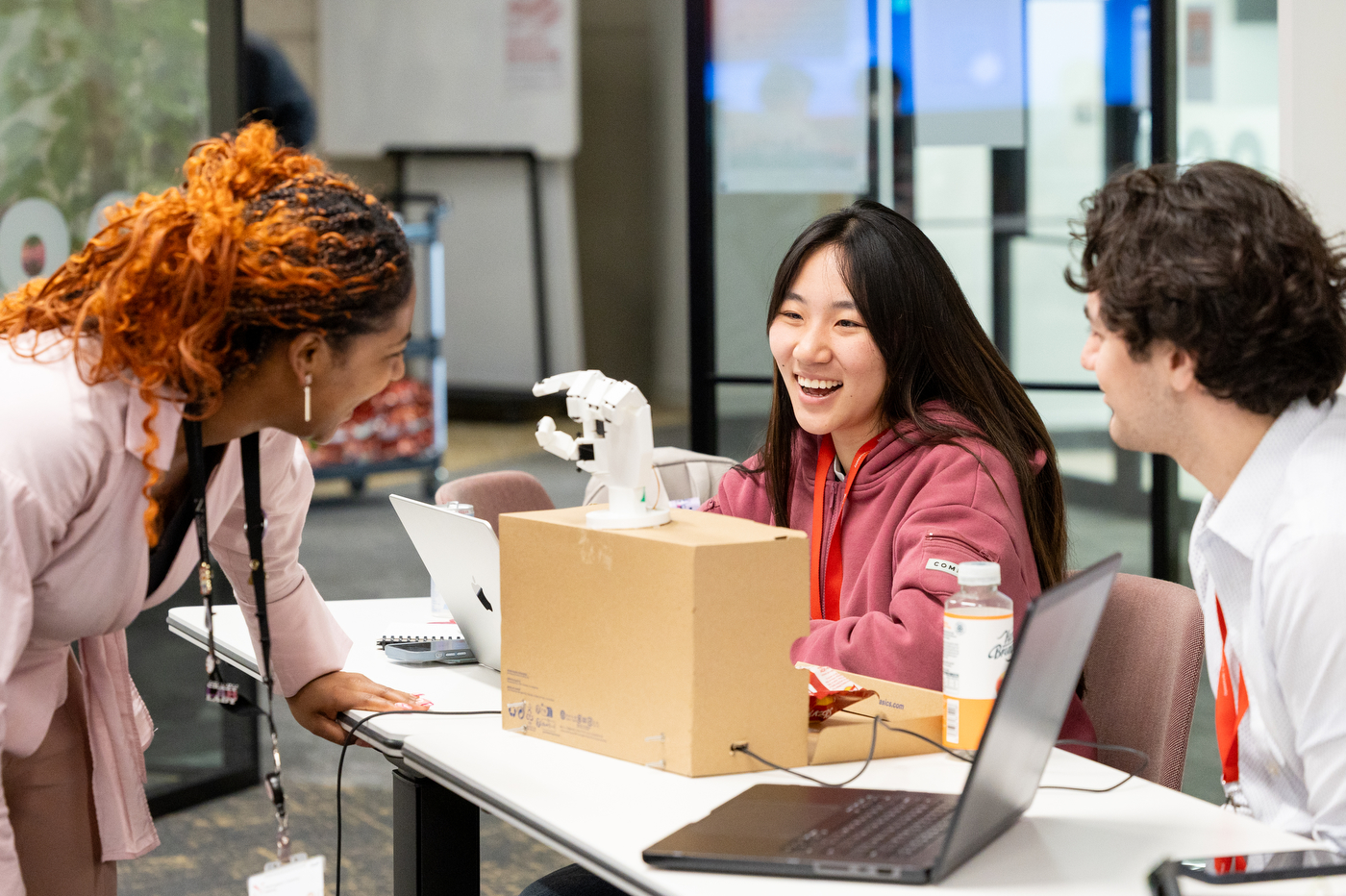 Northeastern students laugh together at a showcase