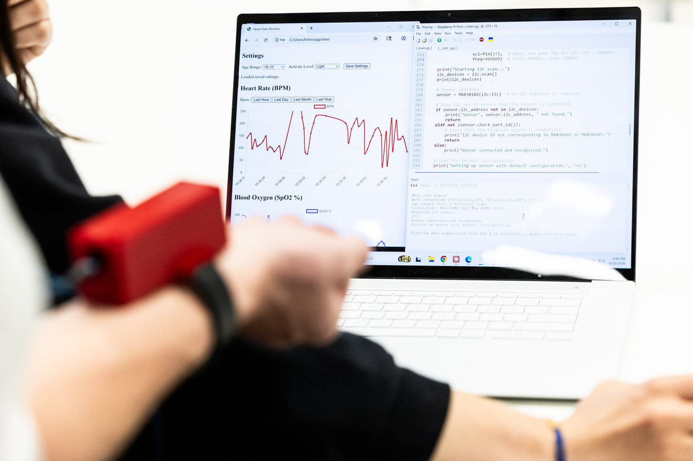 A computer screen shows a graph and text project at a student showcase