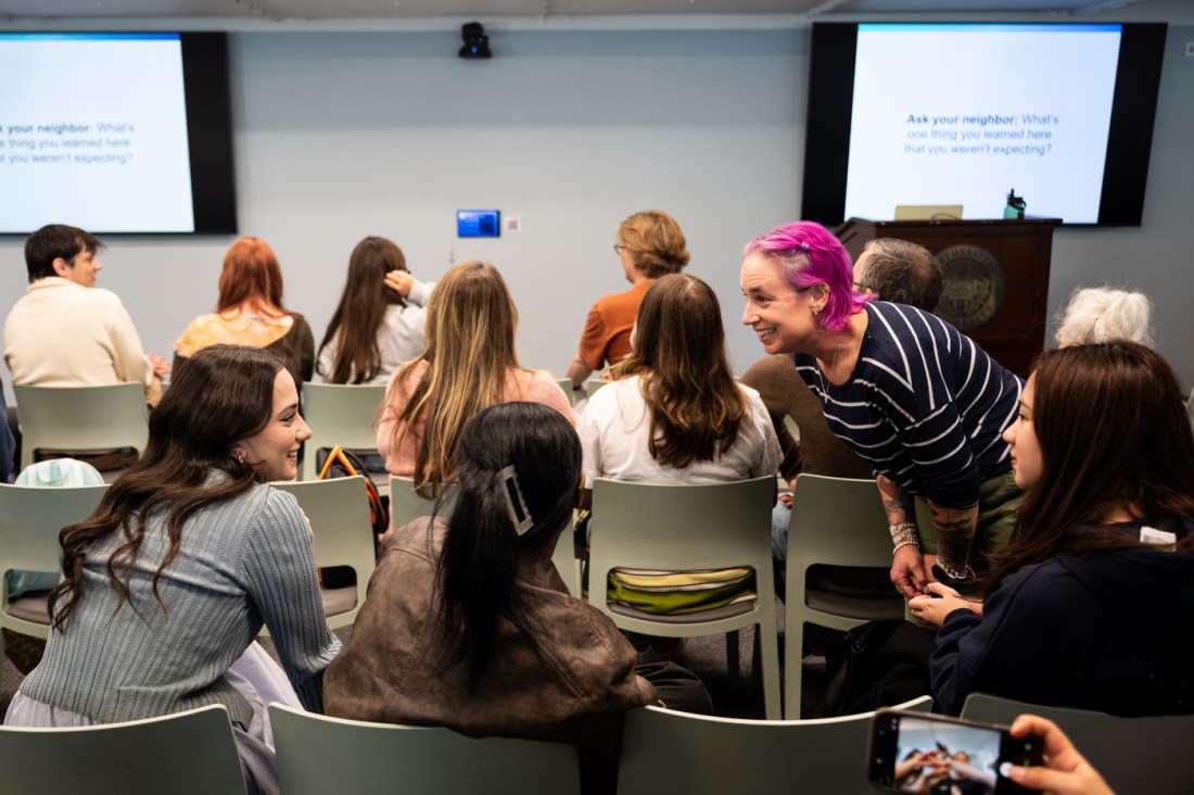 Laney Strange leans over audience members during her Last Lecture 2026 address at Northeastern University.