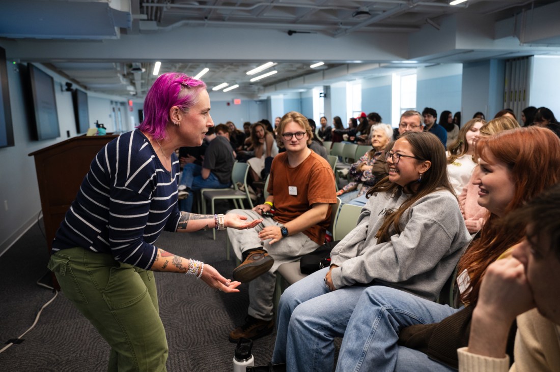 Laney Strange leans toward a laughing crowd of students during her Last Lecture 2026 address at Northeastern University.
