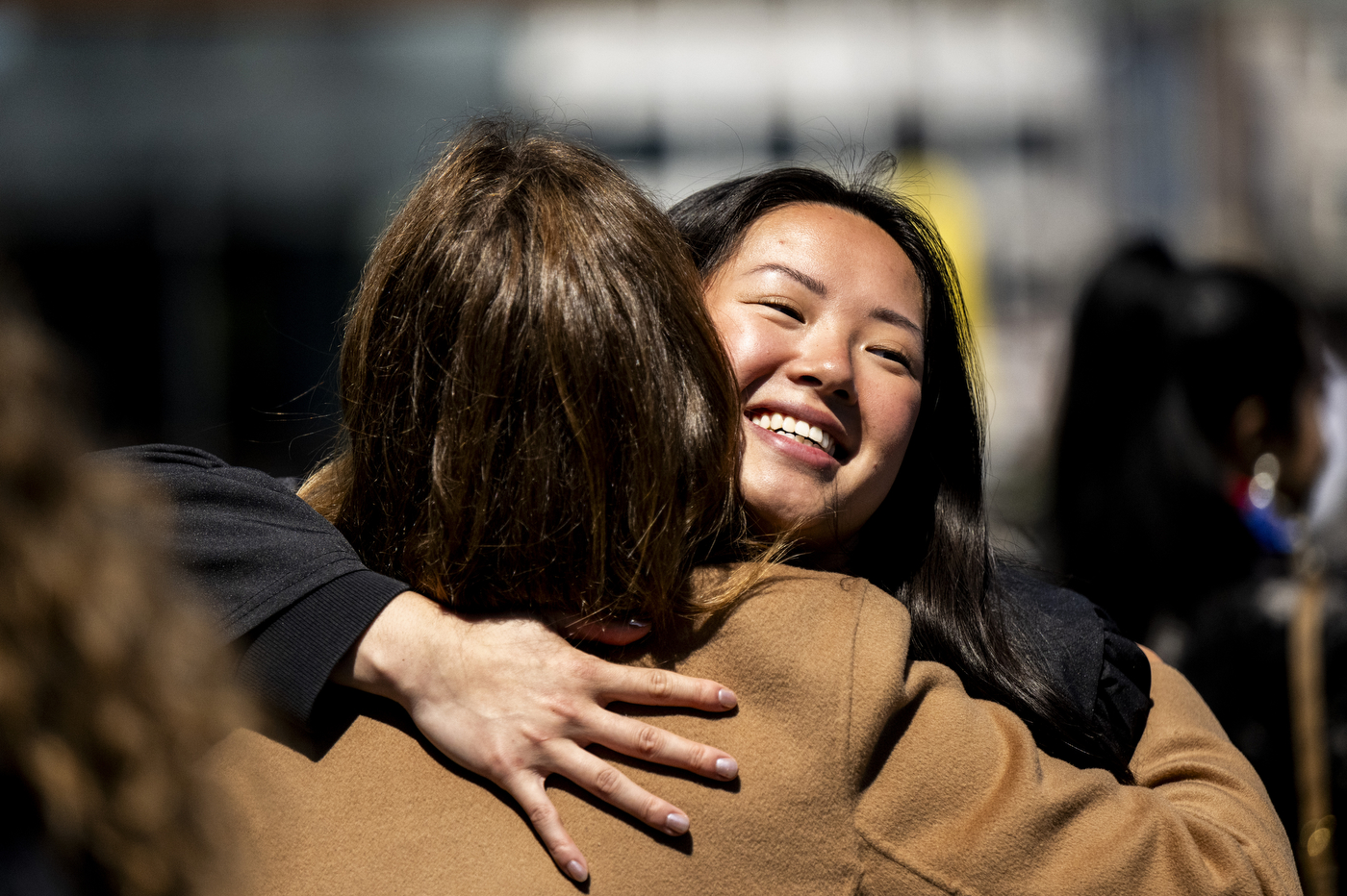 Two people embrace in a hug.