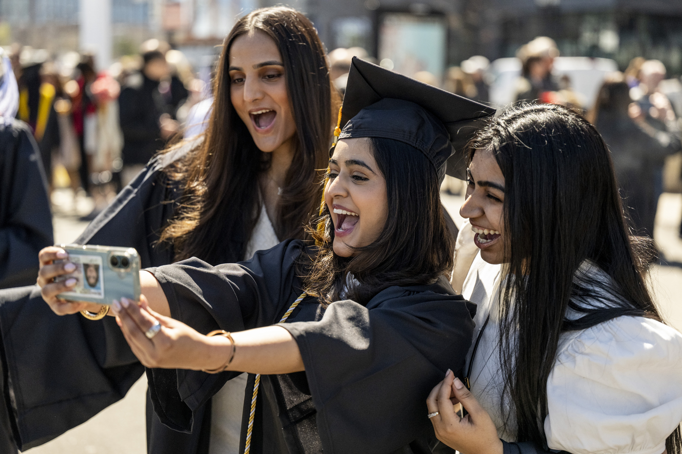 Three graduates pose for a selfie.