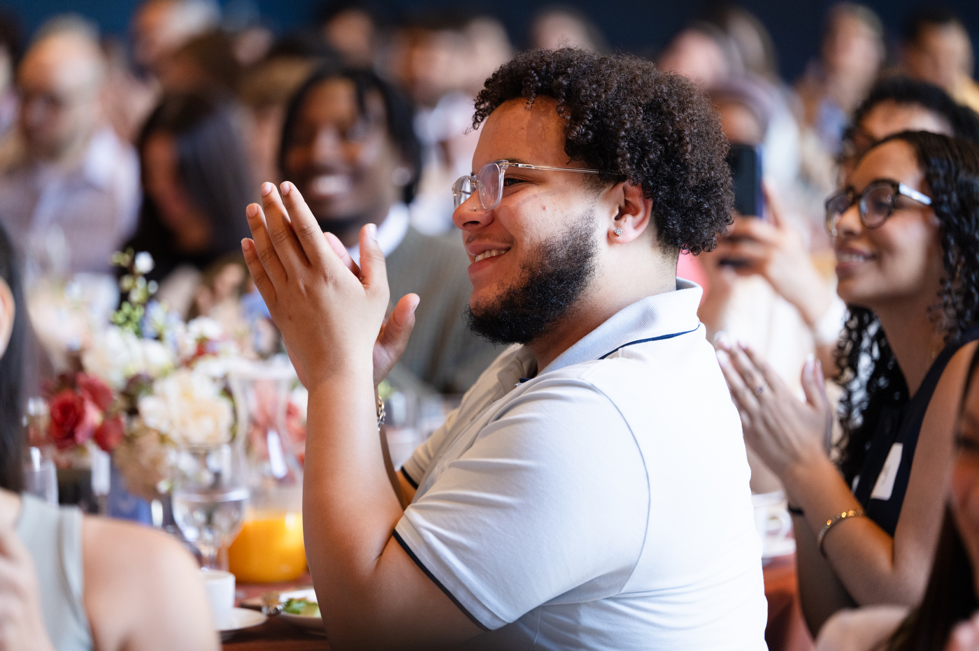 Audience members clapping at an event in the Curry Ballroom.