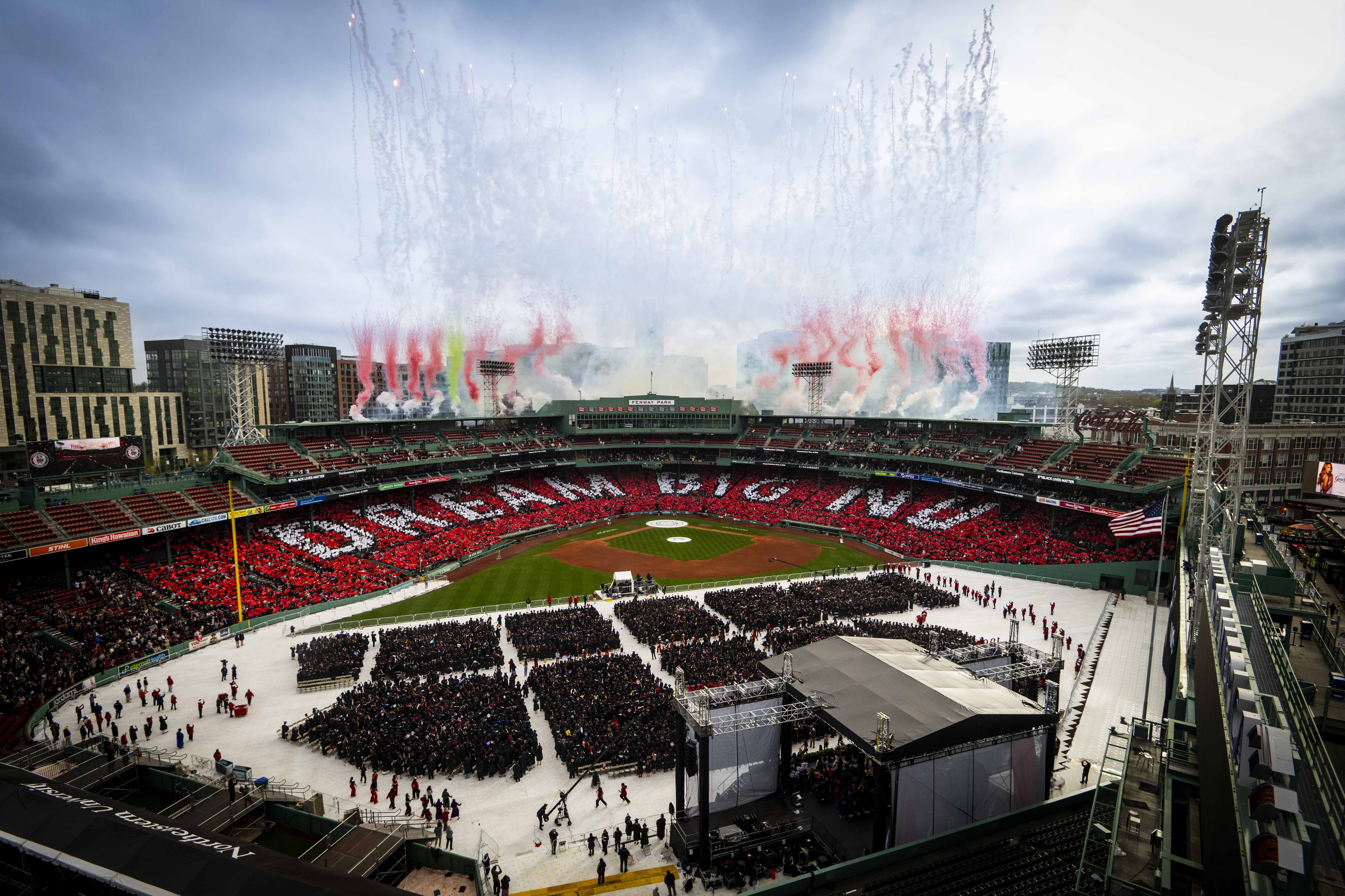 A wide shot of fireworks going off during the commencement finale at Fenway Park.