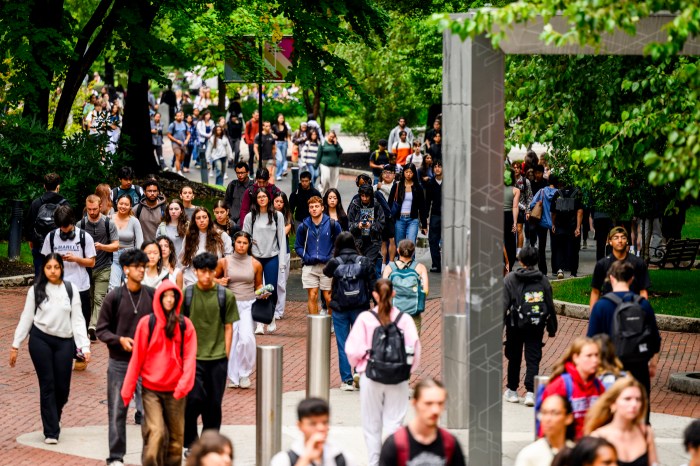 Groups of students walking through Northeastern University's Boston campus.