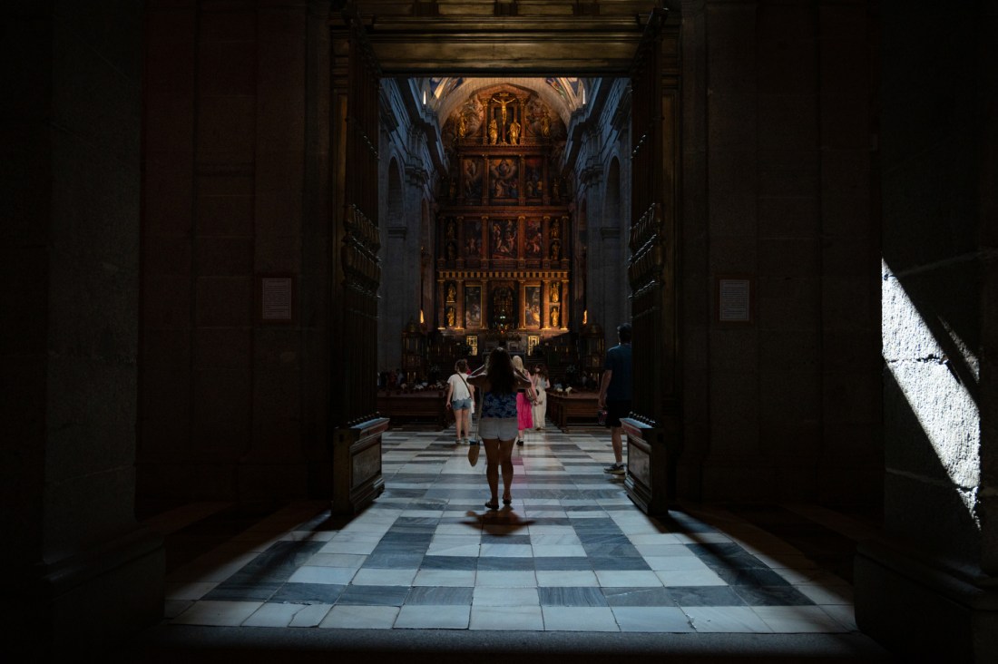 A group of students walk into a dimly lit church.