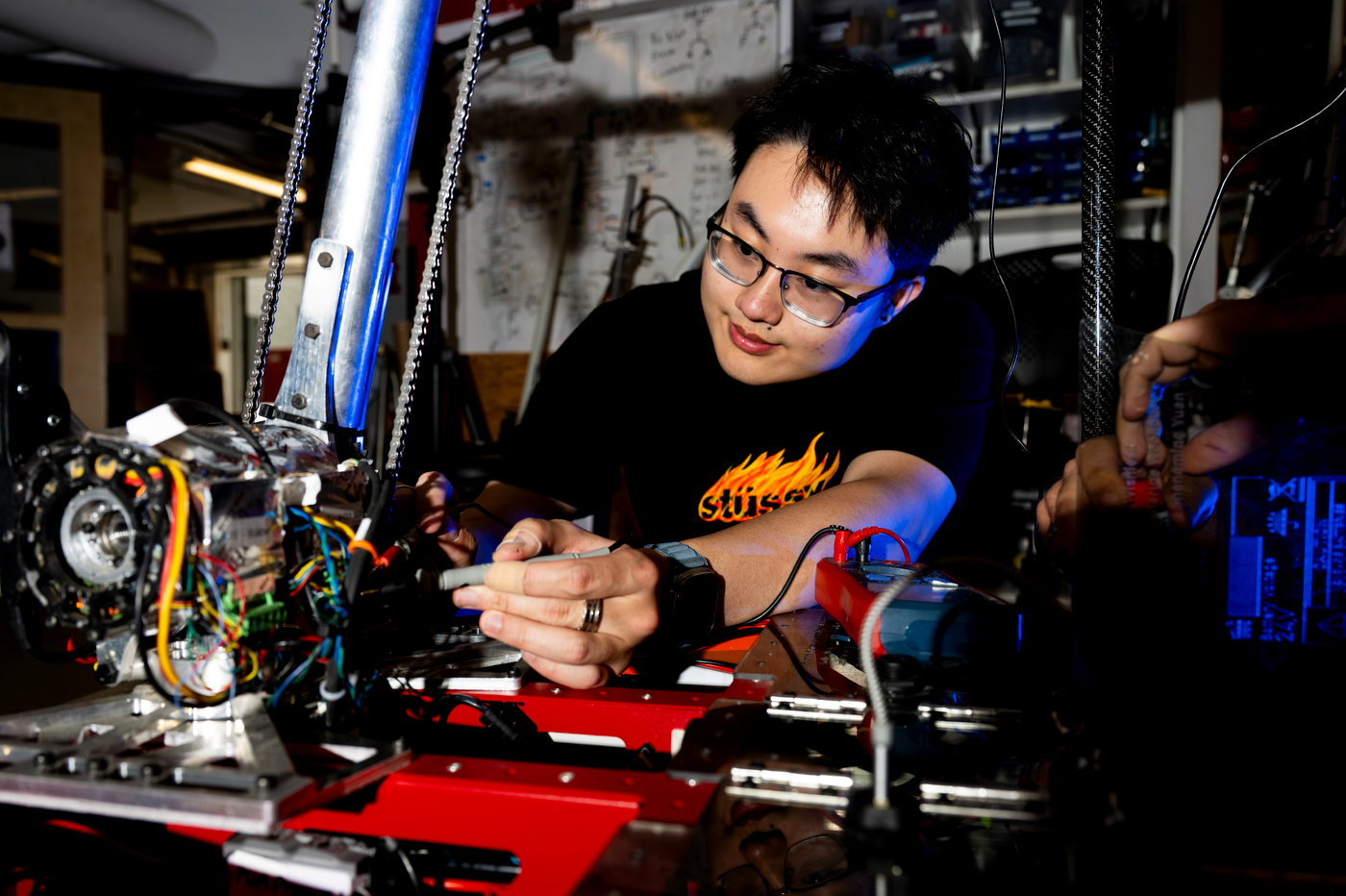 Shaan Merchant works on the team's mars rover.