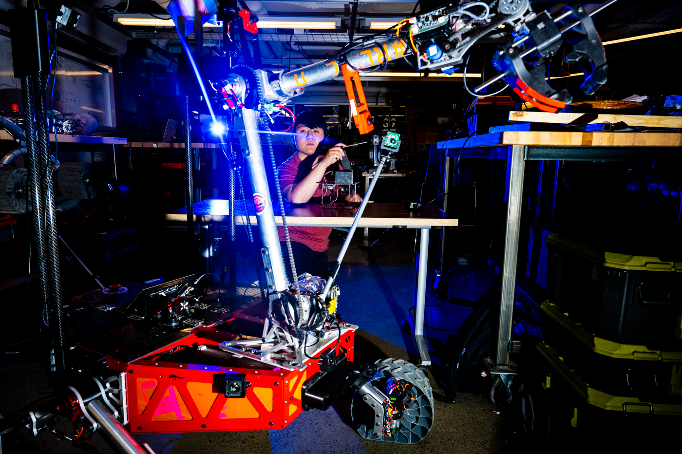 A Northeastern student works on the Mars Rover team's machine, built by students.