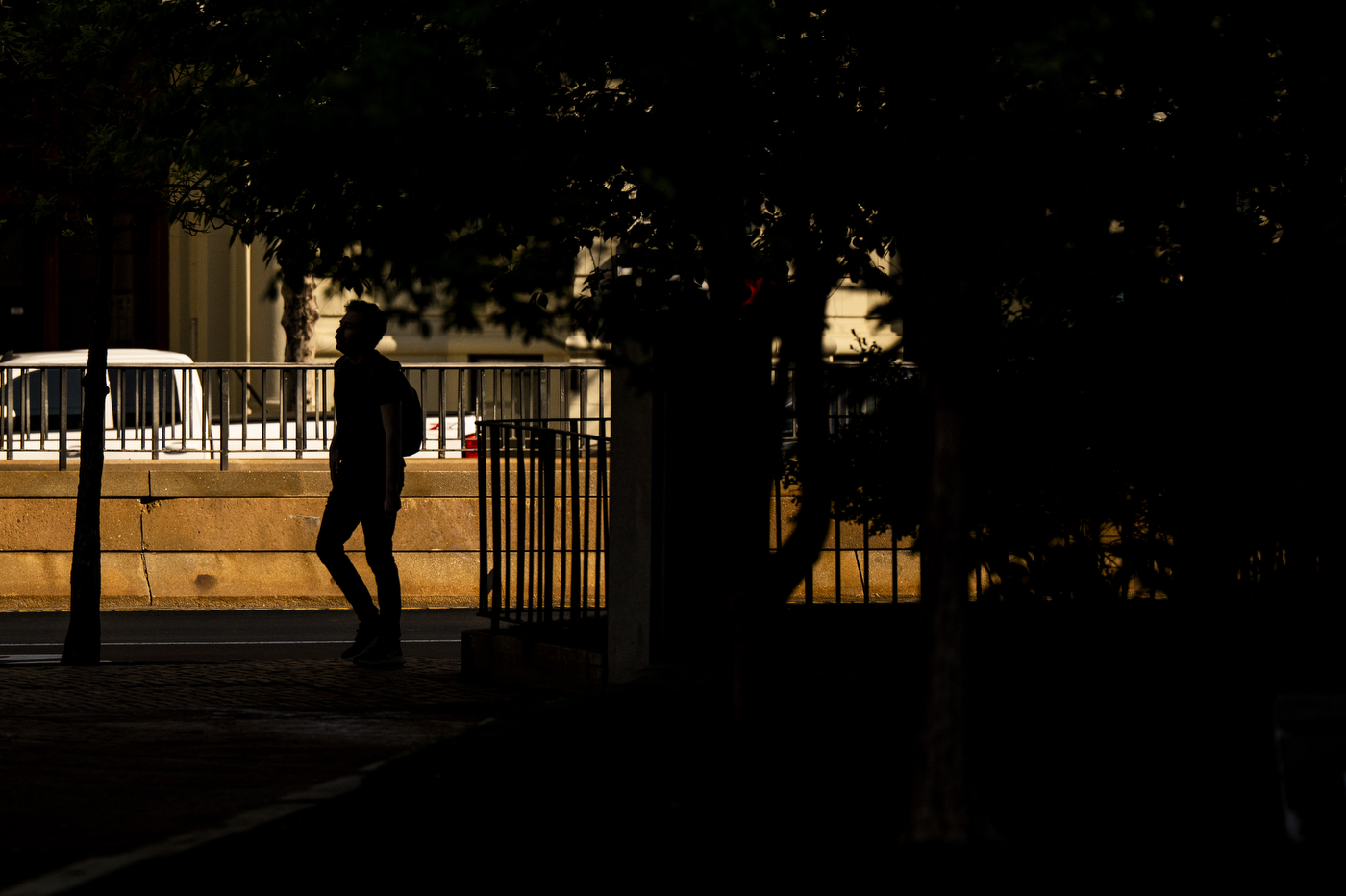 The silhouette of a students walking down the busy Huntington Ave street.