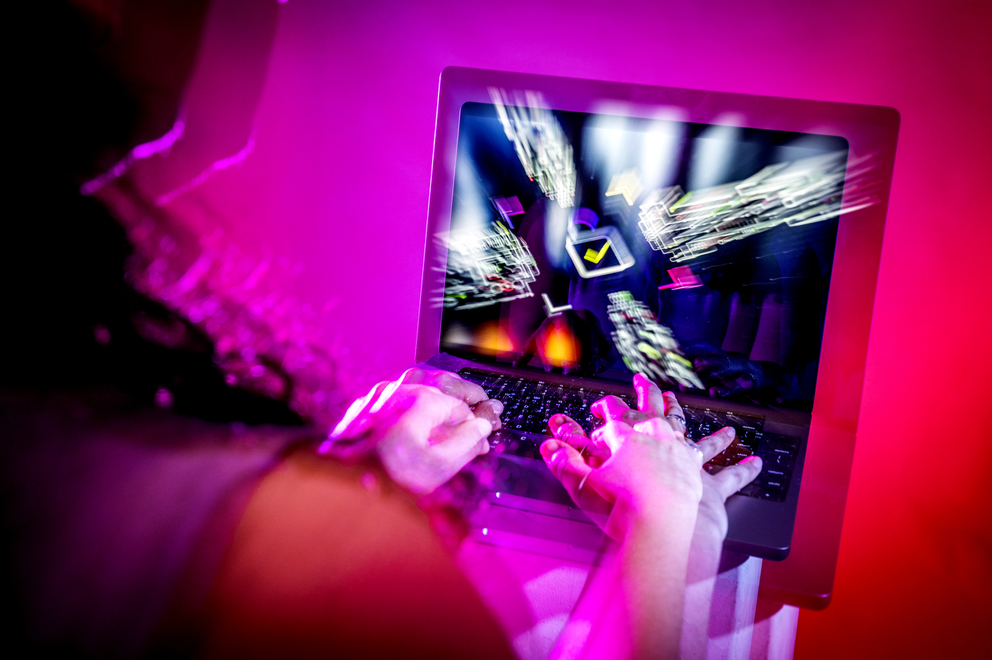 A stock photo of a person typing on a laptop with a camera effect making the image on screen 3D.