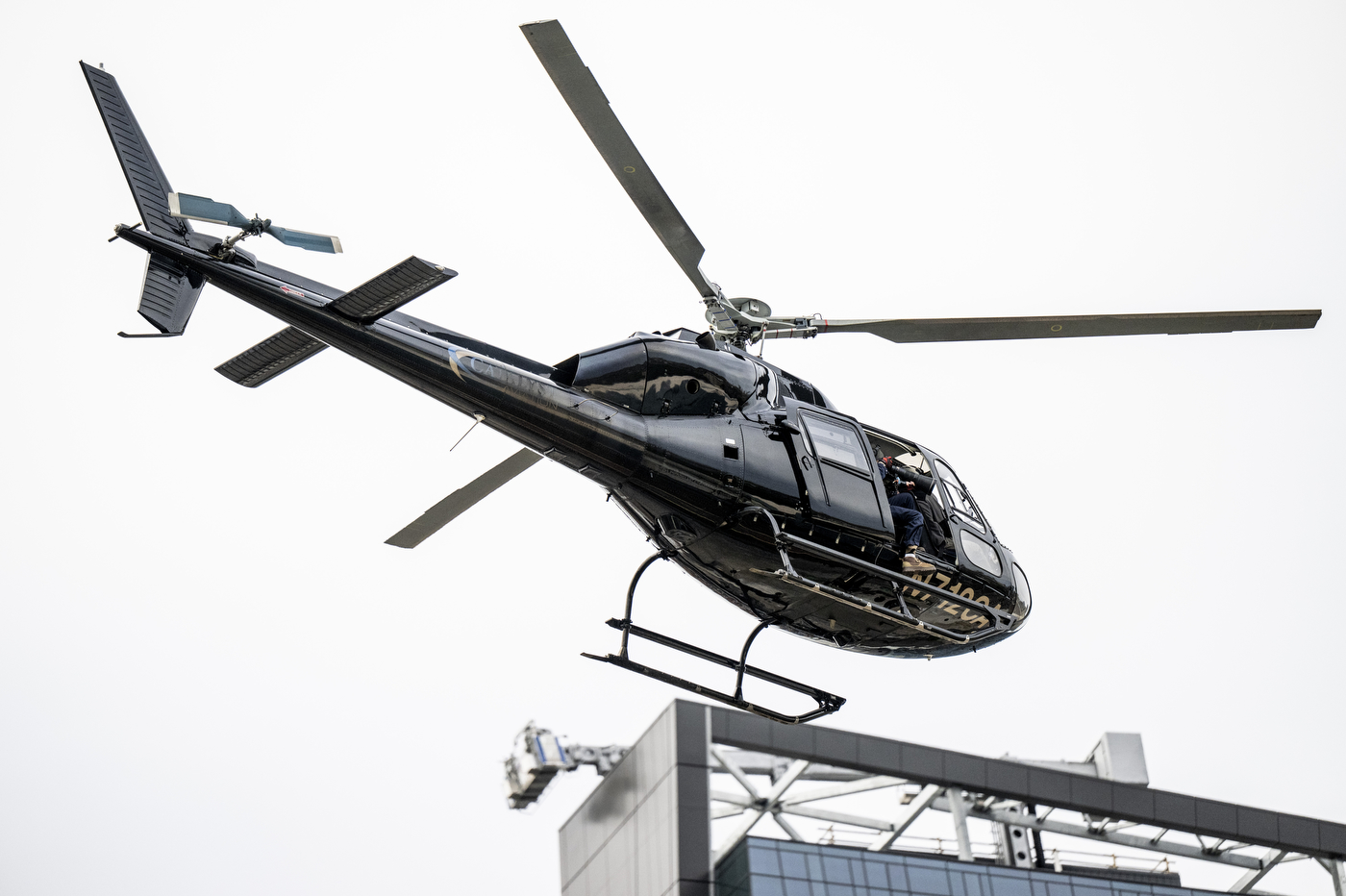 A closeup of a helicopter flying over campus.