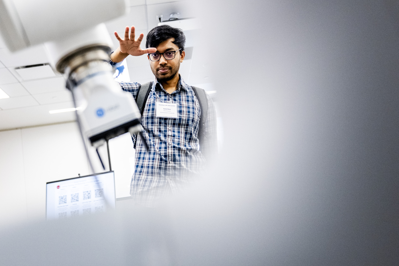 A Ph.D. student interacts with a robot demo.
