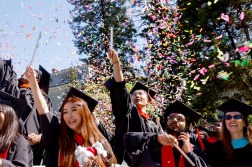 Oakland graduates celebrate with confetti.