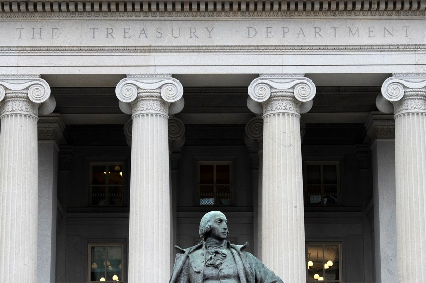 The exterior of the U.S. Treasury Department building in Washington, with a statue in the foreground.