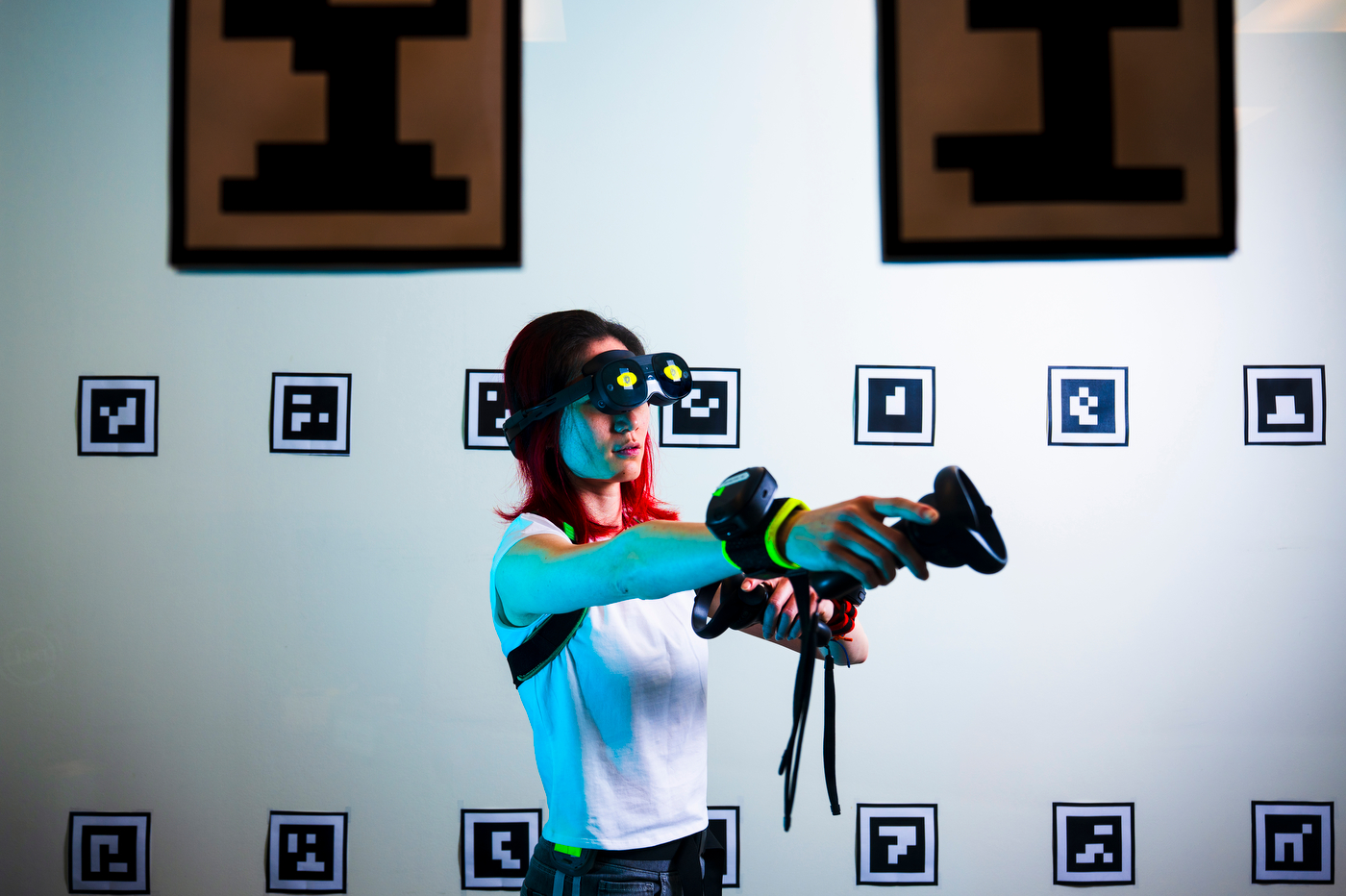 A researcher wearing VR tech gear demonstrates usage.