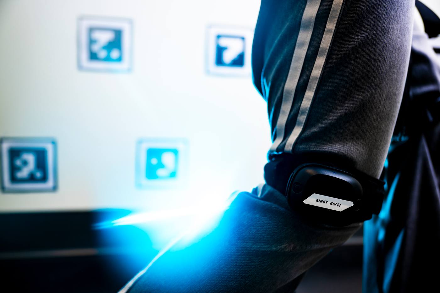 A close up of a person's arm strapped with a wearable techonology.