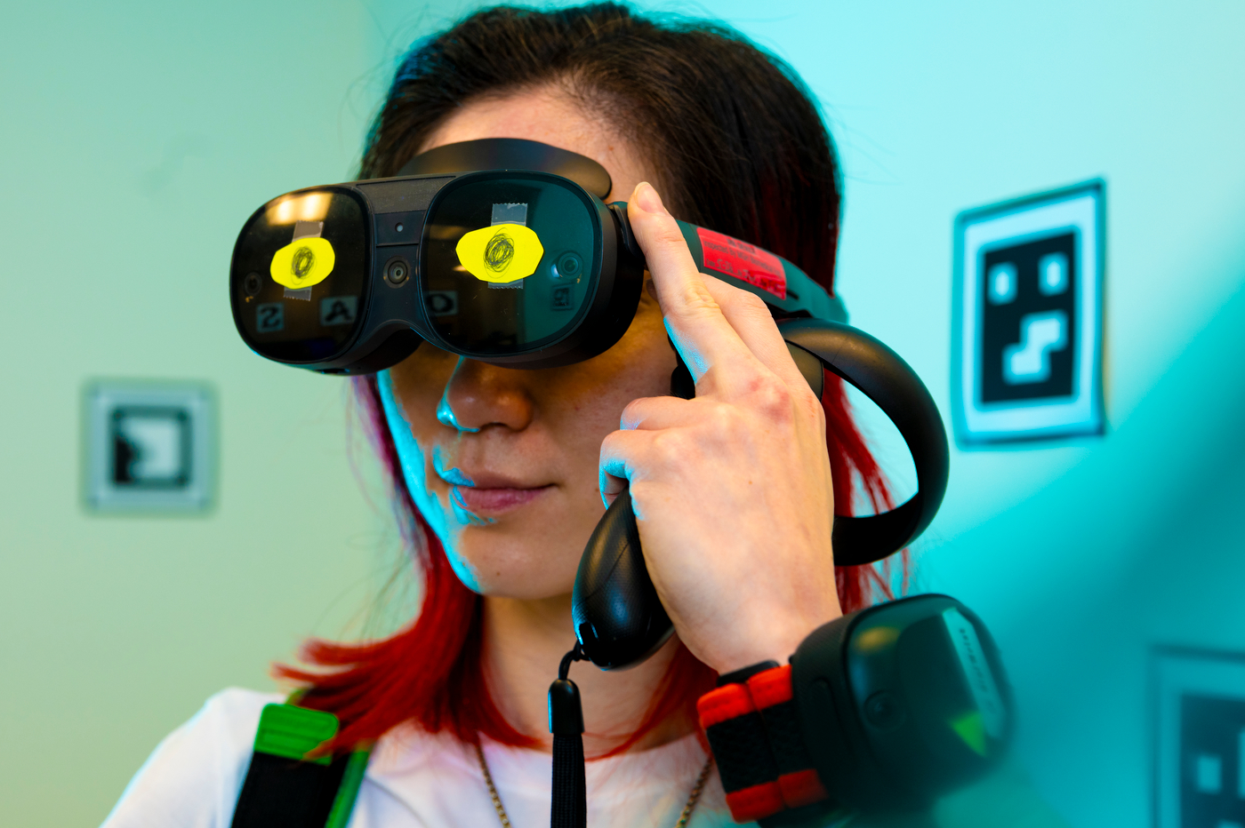 A person wears a VR headset with pieces of paper mimicking eyes.