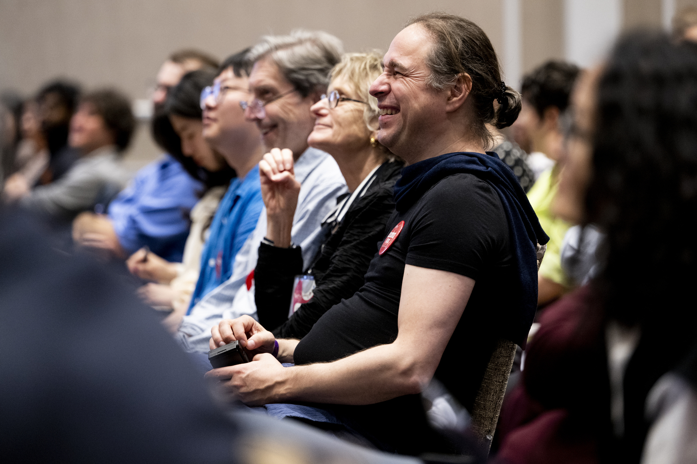 Audience members laughing and engaged during a session at NetSci Boston 2026. 