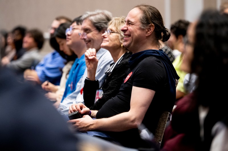 The audience listens to a physics professor during a university lecture.