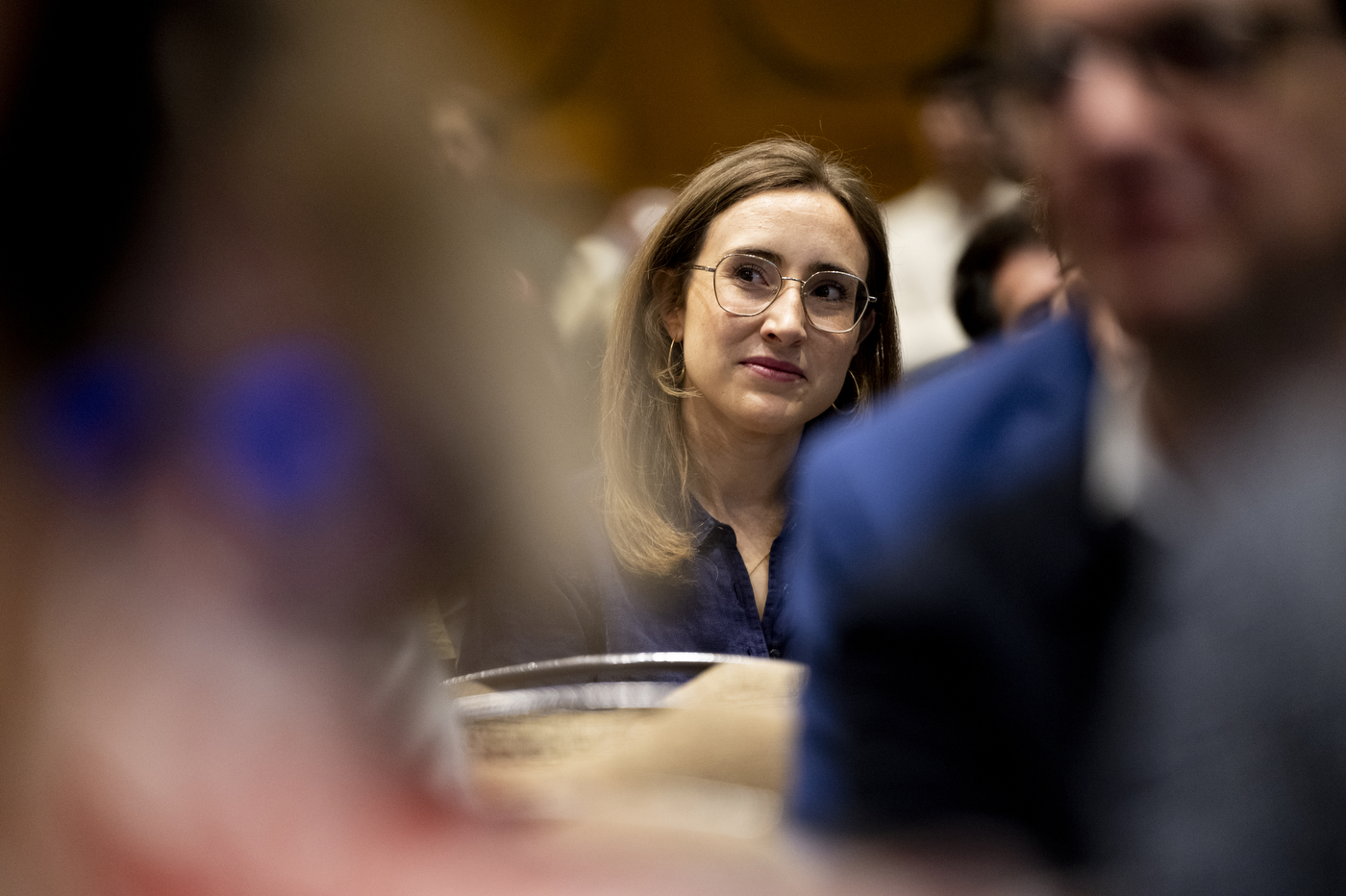 A conference attendee listening during a session at NetSci Boston 2026. 