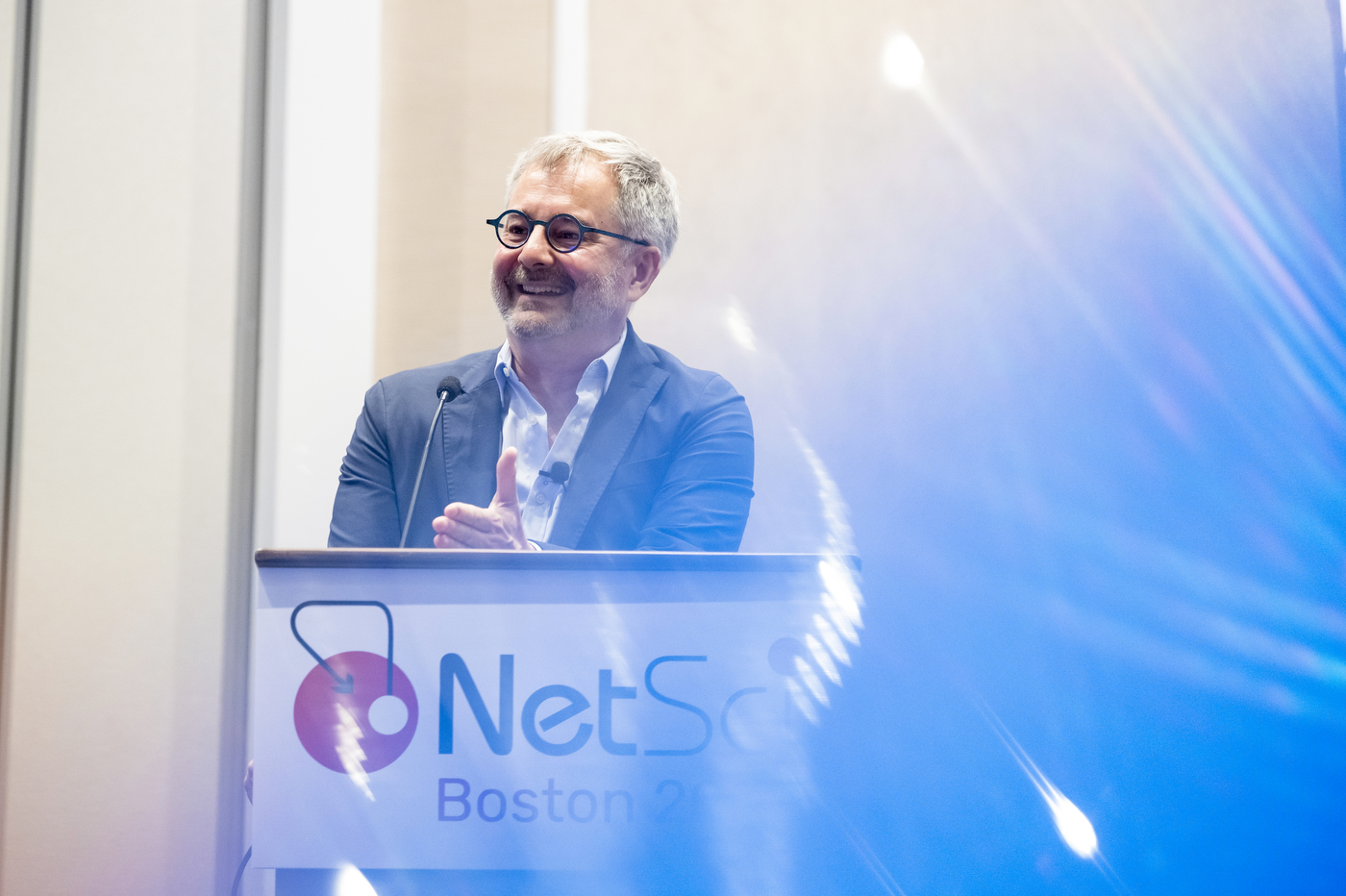 László Barabási speaking at the NetSci Boston 2026 podium during his joint keynote address.