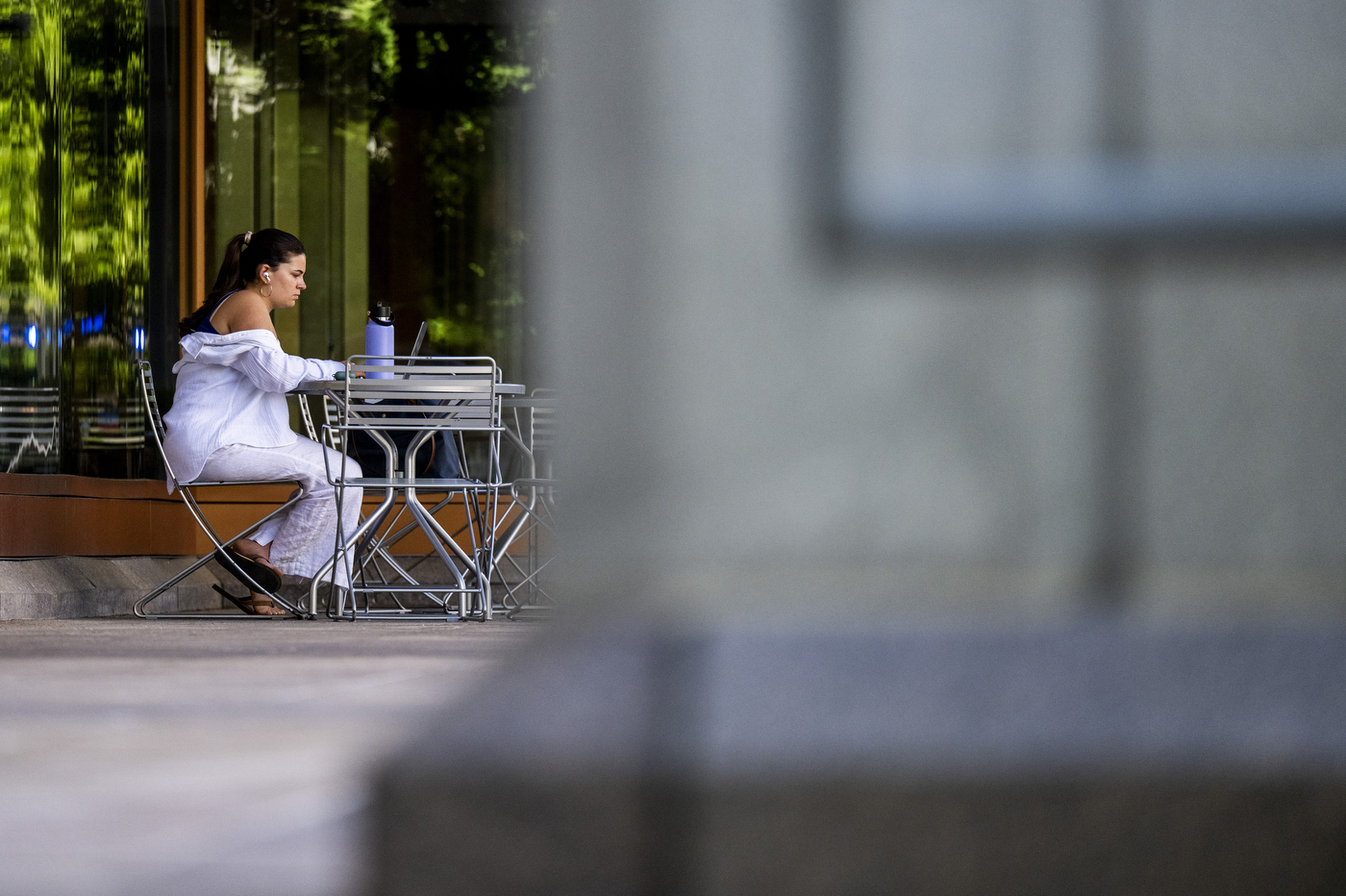 A student sits on a stable outdoors.