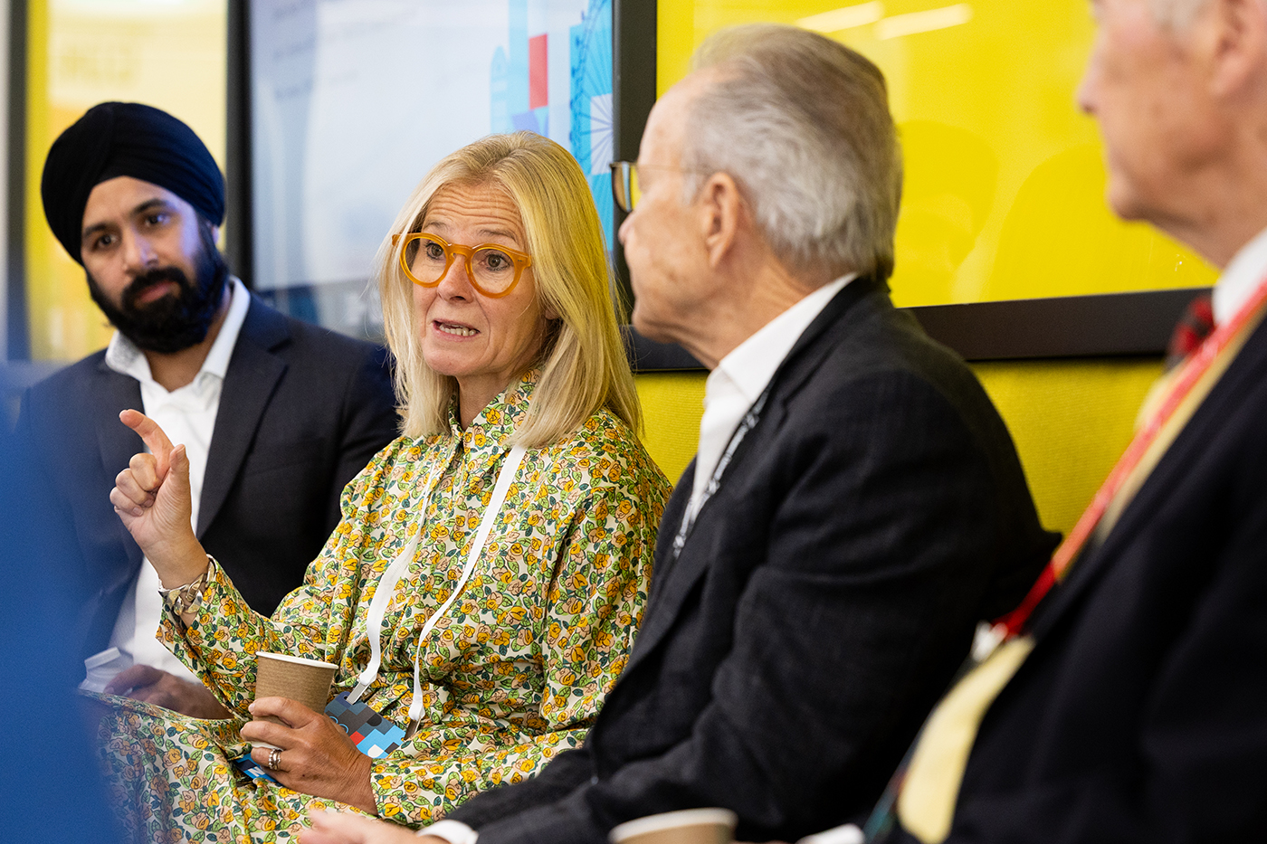 A woman speaks to fellow panelists during a discussion at the Global Leadership Summit.