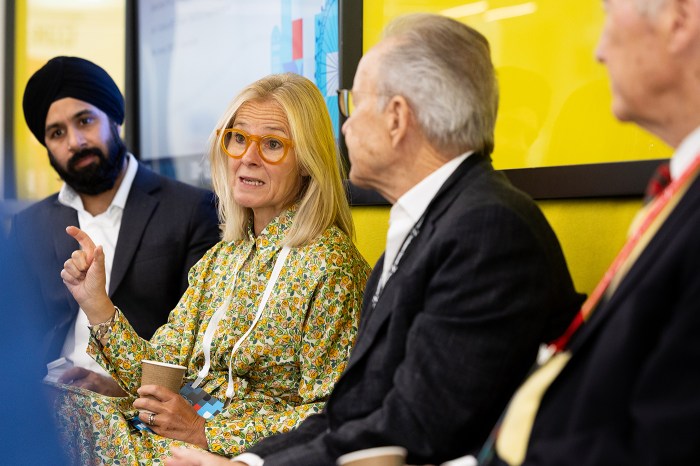 A woman speaks to fellow panelists during a discussion at the Global Leadership Summit.