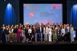 A gathering of several dozen attendees join Northeastern President Joseph E. Aoun on stage at the Global Leadership Summit in London.