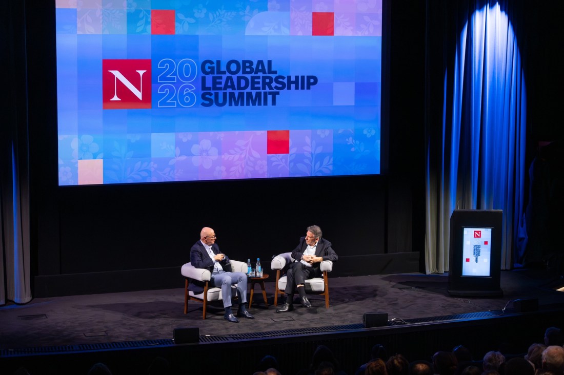 President Aoun and Sir Lucian Grainge seated on stage at BAFTA beneath a large screen displaying the Northeastern Global Leadership Summit 2026 logo.