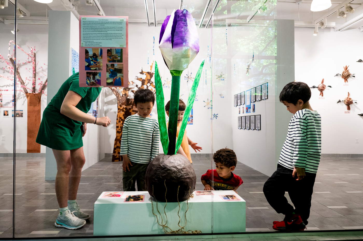 Several children observe and interact with art in an exhibit at Gallery360.