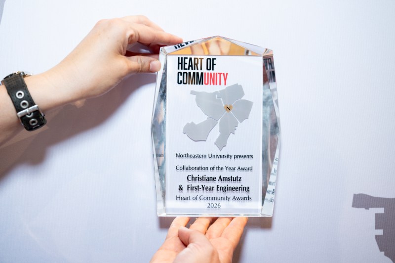 Hands hold a Heart of Community aware.