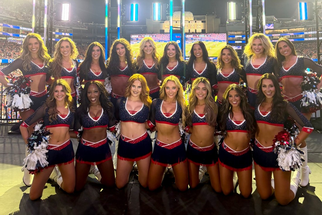 The team of Patriots cheerleaders poses for a photo while wearing uniforms.
