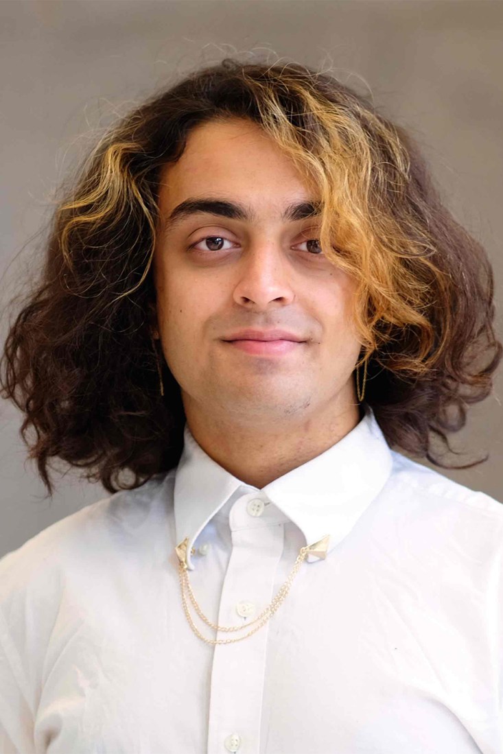 Portrait of Sagar Kumar wearing a white button down. 