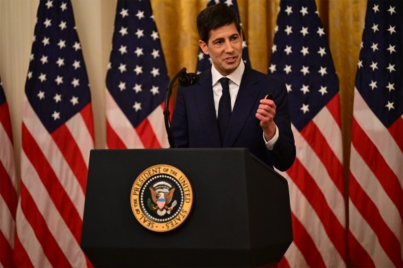 Kevin Warsh, chair of the U.S. Federal Reserve, gestures with his left hand will speaking at a podium with the United States seal.