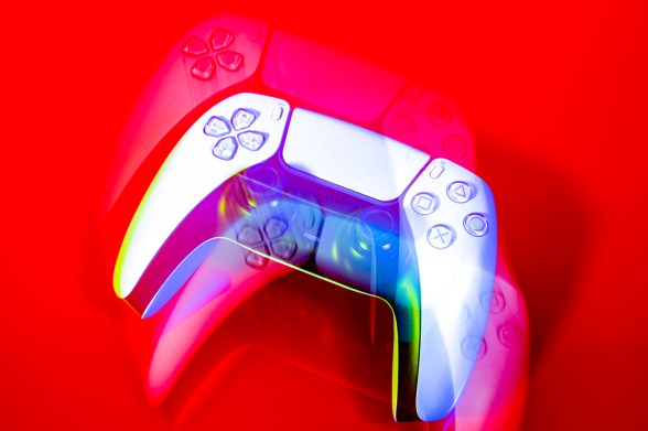 A close up of a Playstation controller on a red background, with a camera affected added to appear as if there are multiple, multicolored controllers.