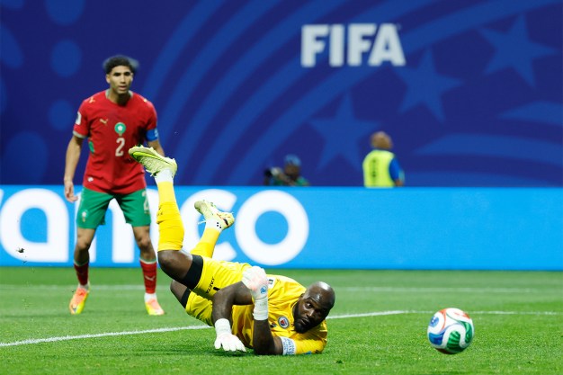 Haiti goalkeeper Johny Placide stretched in the air to save the ball on the pitch as a shot goes wide during the Group C World Cup match against Morocco in Atlanta.