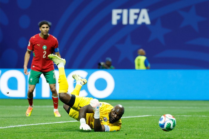 Haiti goalkeeper Johny Placide stretched in the air to save the ball on the pitch as a shot goes wide during the Group C World Cup match against Morocco in Atlanta.