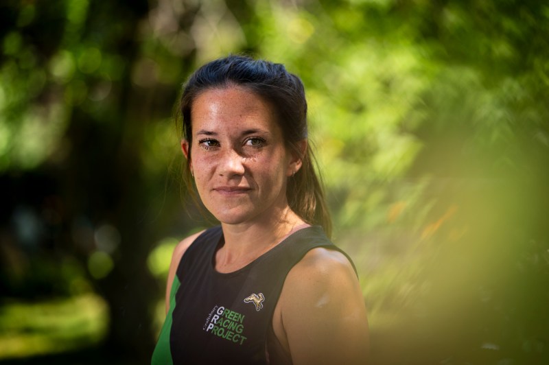 A portrait of Hannah Rowe with green foliage in the background.