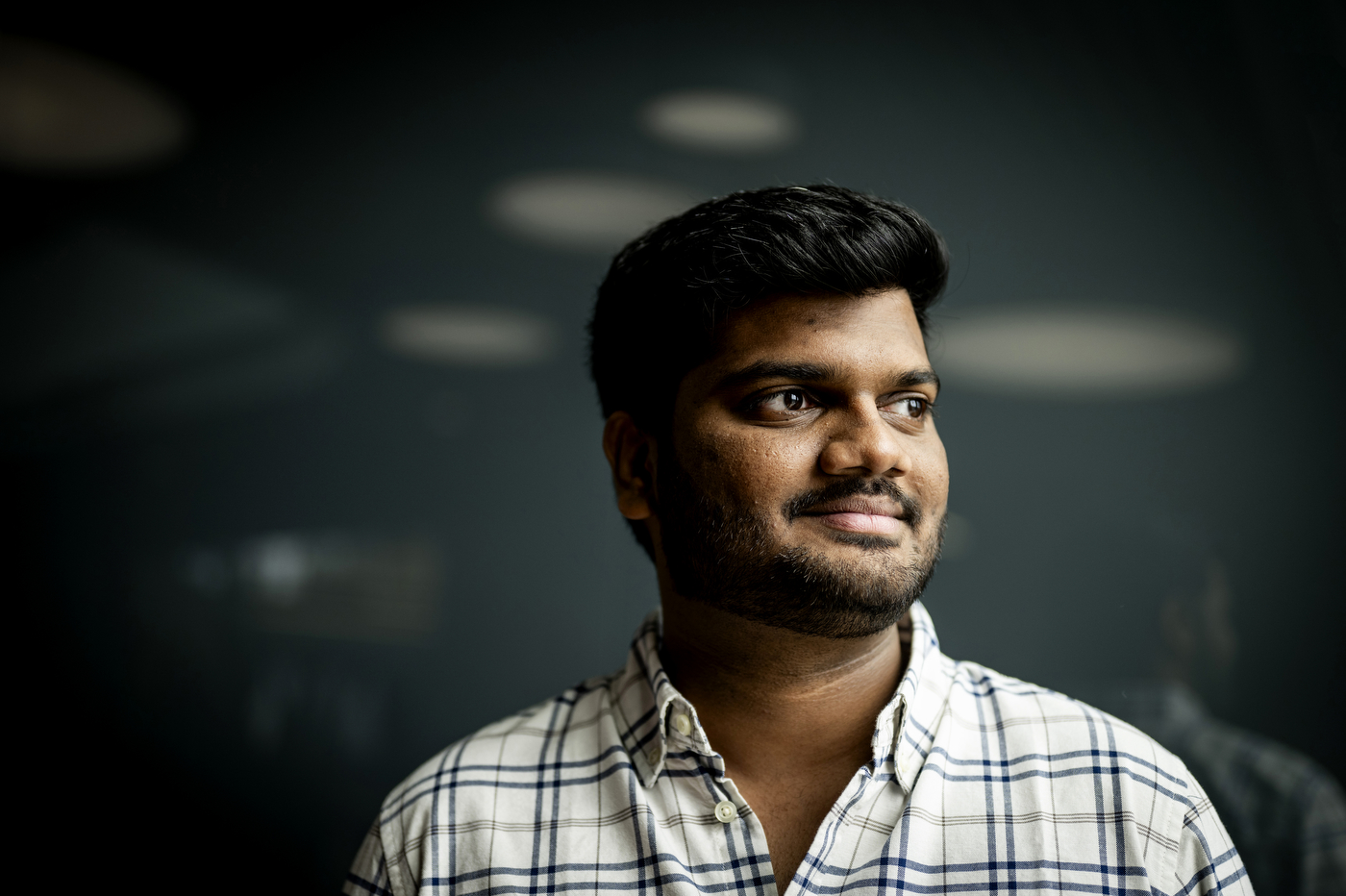 Nihar Sanda, machine learning engineer, looking off to the side against a dark background.