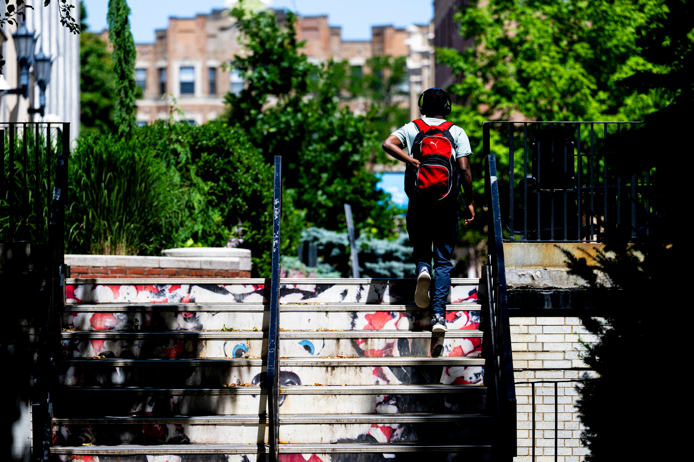 A student walks up campus stairs.