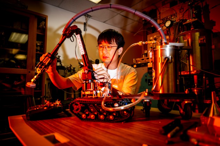 Student Aobo Liu works on a firefighting robot.