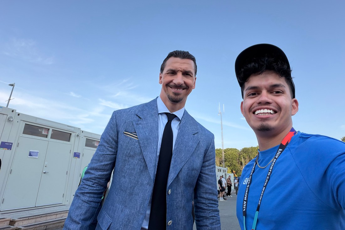 A student on right in a blue shirt poses in selfie with Swedish former football star Zlatan Ibrahimović.