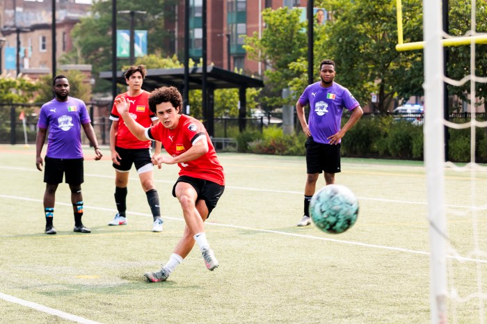 Students play soccer on a field.
