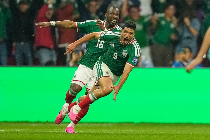 Mexico's Raul Jimenez runs to celebrate on the field.