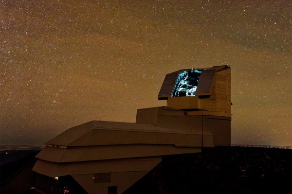 Vera C. Rubin Observatory's dome under a star-filled night sky at Cerro Pach&Atilde;&Acirc;&sup3;n, Chile, with its telescope shutter open and interior lit.
