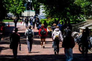 Students walk though Northeastern's Boston campus on a sunny day.